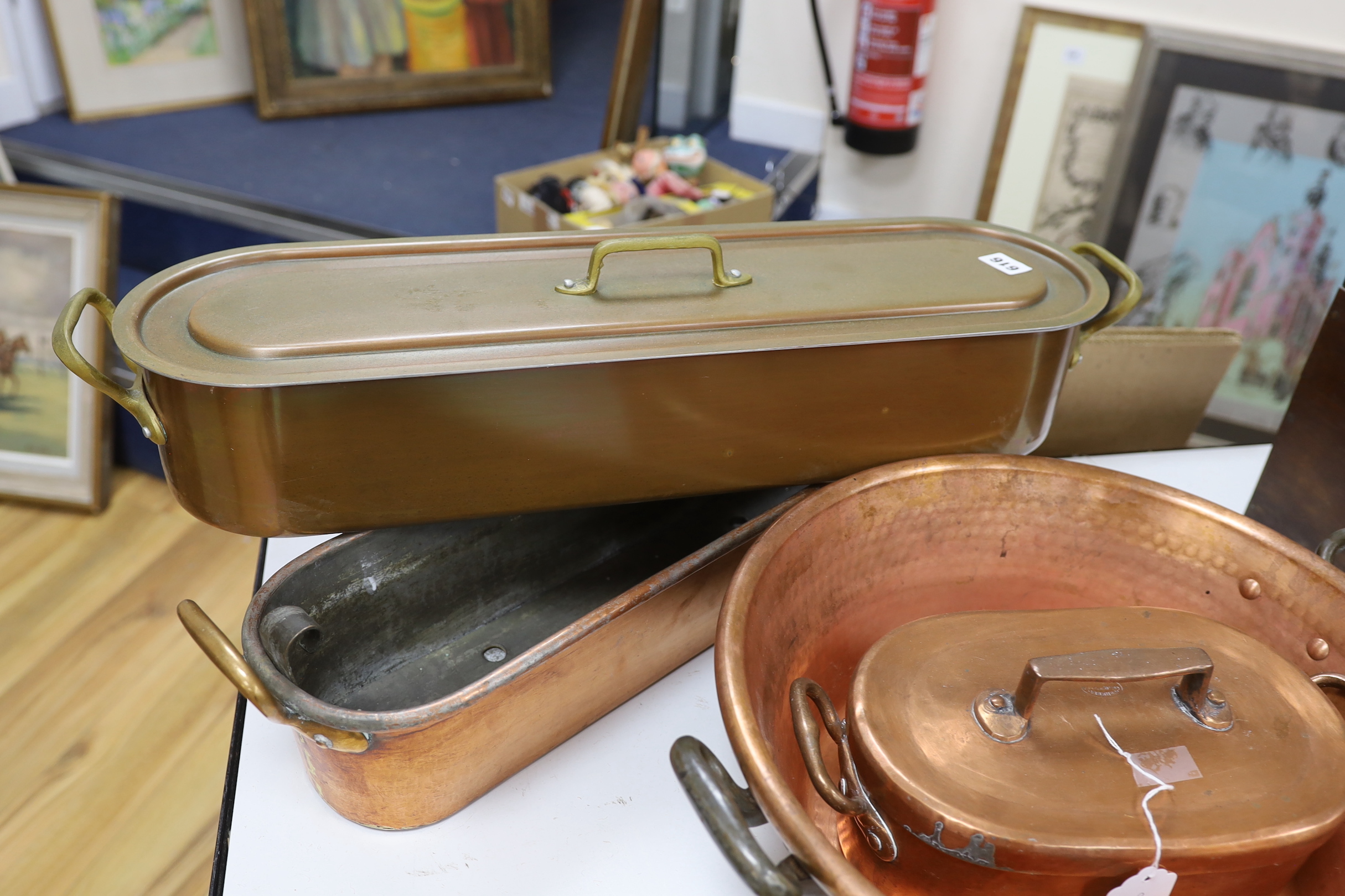 Two copper fish kettles, a casserole dish and cover and a jam making pot, a lidded fish kettle 68cm high